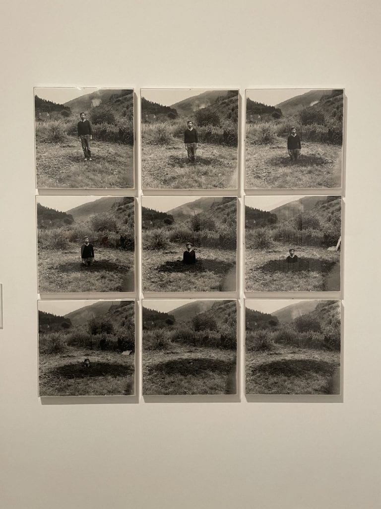 A series of photographs in which a man buries himself.