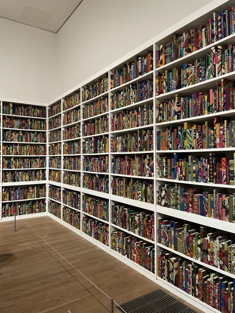 An art installation of bookshelves filled with colorful books.