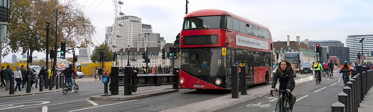 A red double decker bus on the streets of London